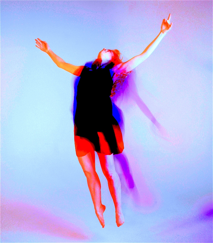 A person jumps mid air with their arms outstretched and facing their head to the sky. They are blurred so it looks as though their shadow is jumping with them. The image is saturated with deep pink and blue.