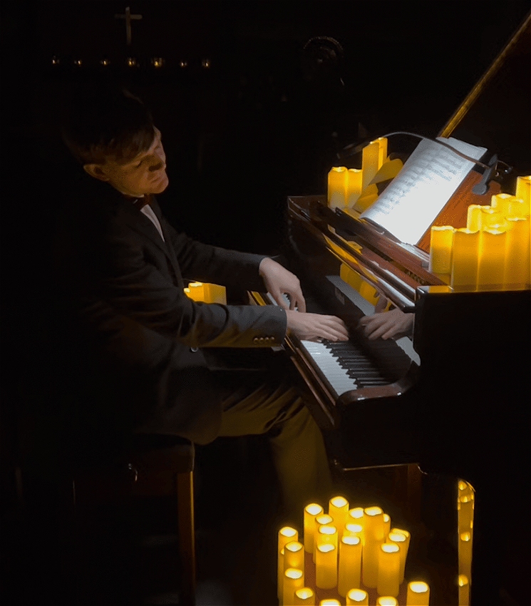 Matthew Shiel plays the piano by candlelight
