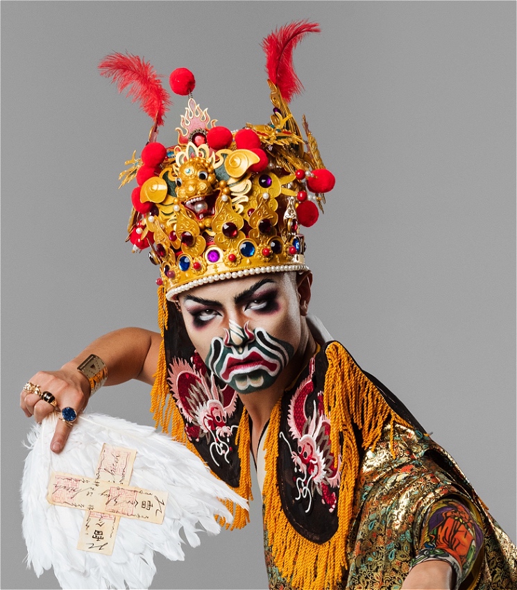 The image features a drag king from Taiwan, adorned in a costume inspired by Taiwanese folk culture. The makeup blends JC the GUY’s signature style with elements of Ba Jia Jiang makeup—a traditional art form used in religious ceremonies. This fusion of modern drag and ancient ritual highlights the unique cultural storytelling at the heart of the performance.