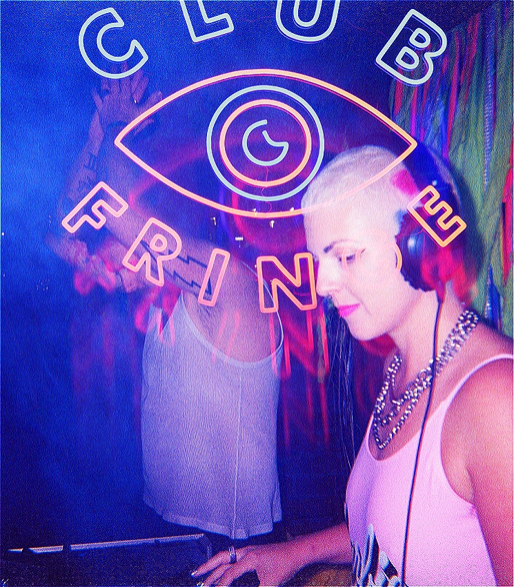 A hazy and artfully blurred image of a white person with pink lipstick and a shaved head wearing headphones while DJing on decks. Behind them is a white dancer with their hands in the air and a lighting strike tattoo is visible on their bicep. The room is smokey around them. The image is overlayed with a neon logo which reads: CLUB FRINGE. In the middle of the two words is an the shape of an eye, with a crescent moon as the iris.