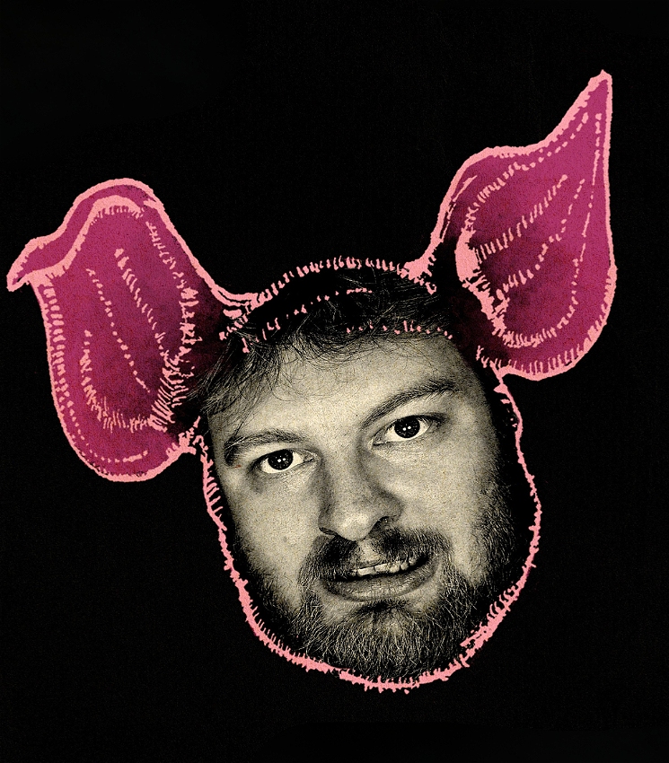 Barney in a cartoon pig ears with a black background.