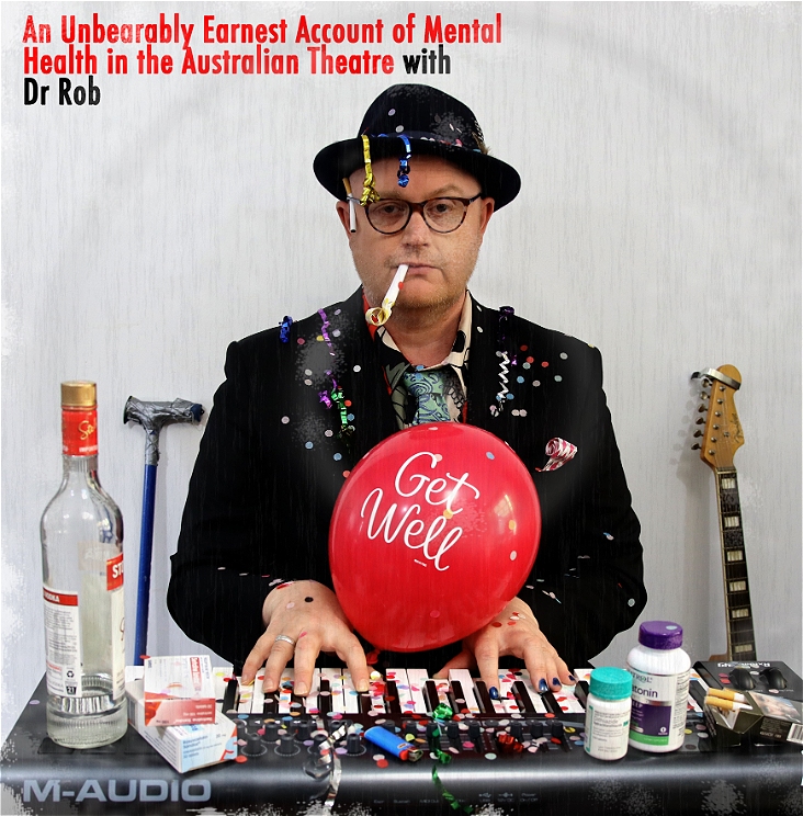 Dr Rob sits at a keyboard surrounded by the evidence of a party, streamers and poppers, vodka and anti depression pills. They do not look impressed.