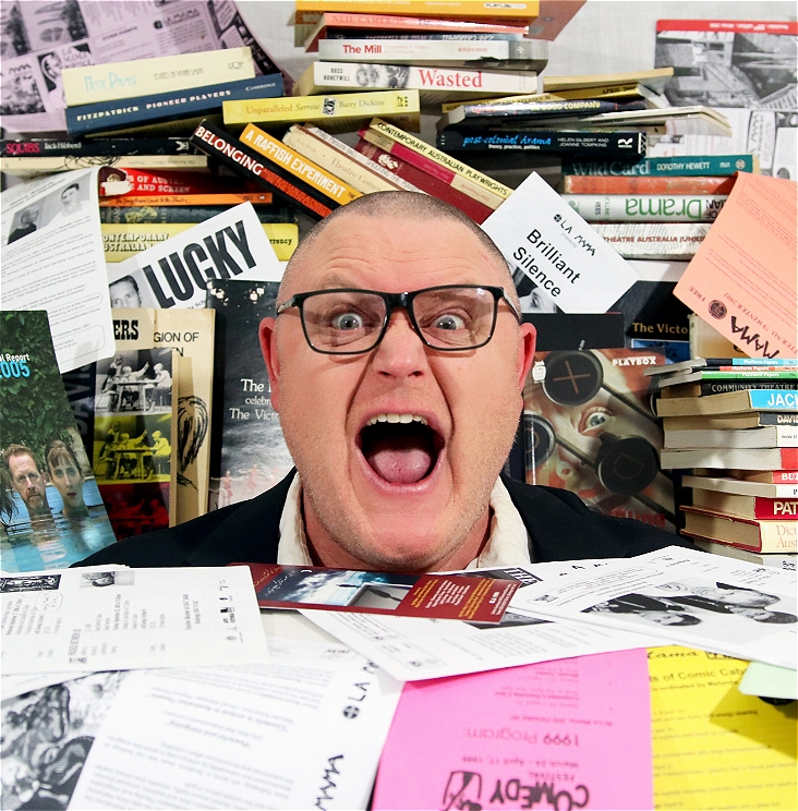 Dr Rob is surrounded by press releases, fliers and books about Australian Theatre. They are shouting.