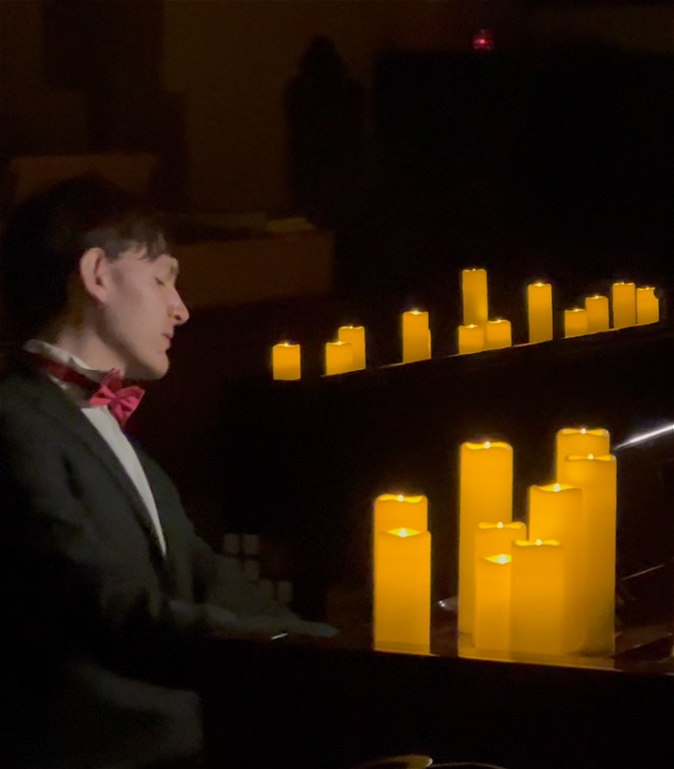 Matthew Shiel plays the piano by candlelight