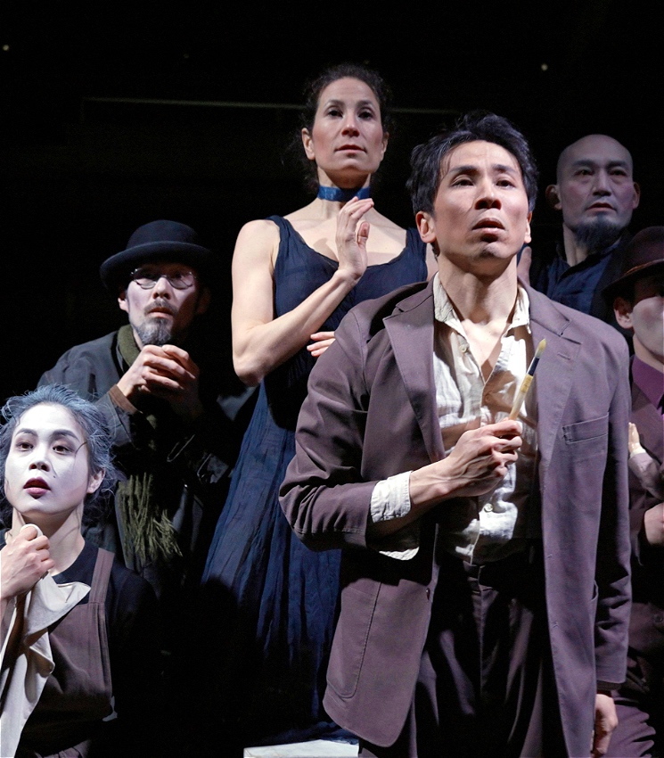 A group of people stand looking at the camera